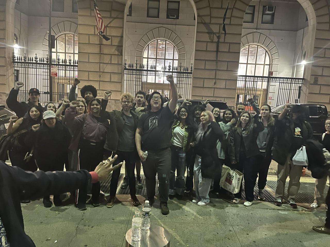 A group of people standing outside of a building.