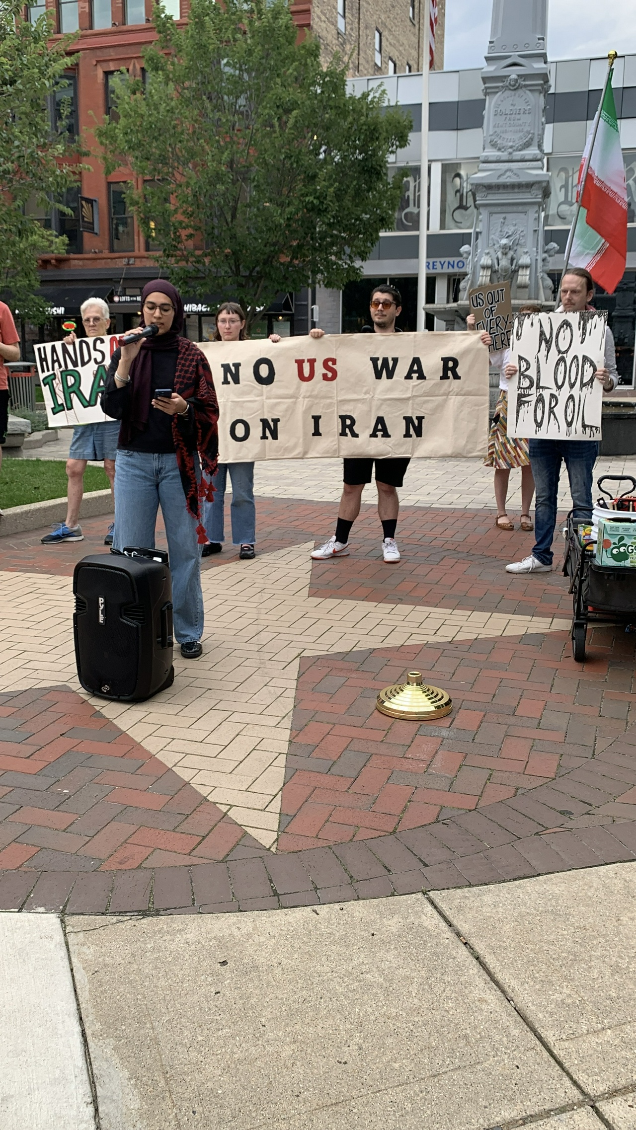 Protesters hold signs and banners.