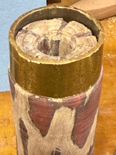 Knife handle with a step turned on the end of it, and a 1 inch diameter piece of brass tubing placed on the end