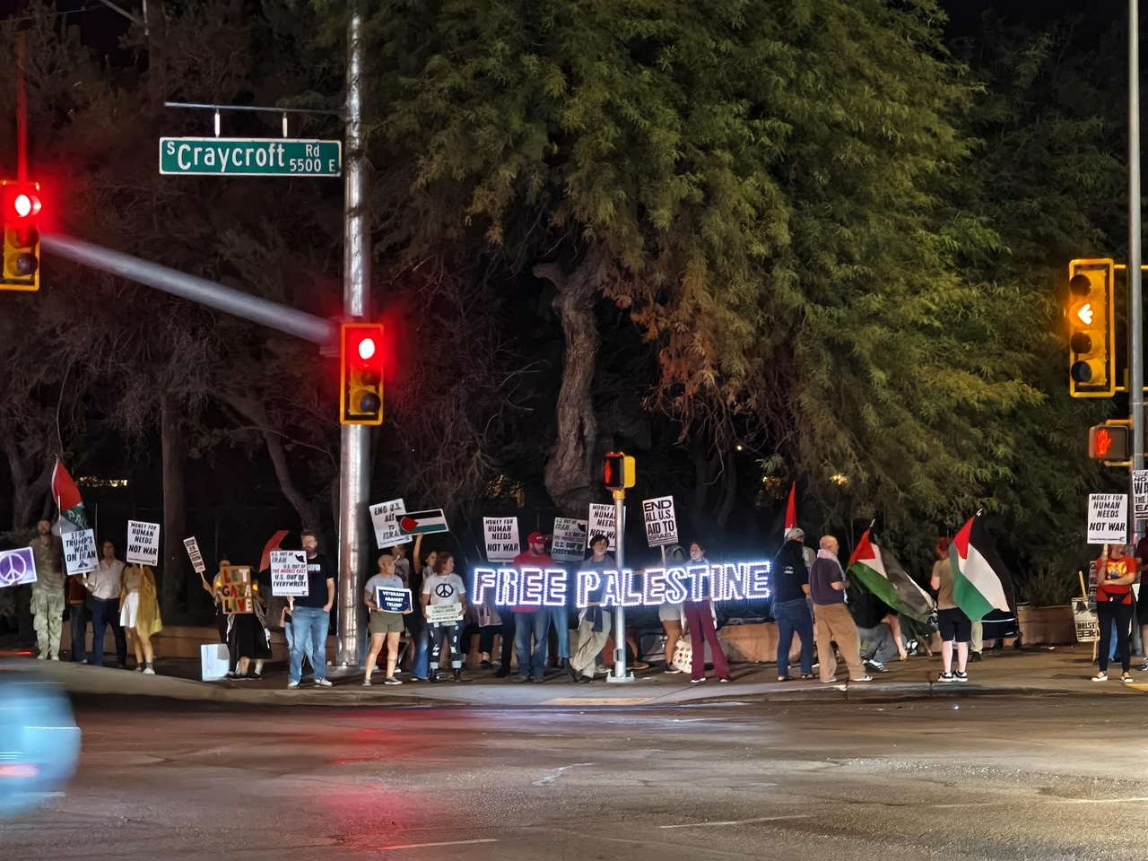 A group of protesters holdings signs and banners.