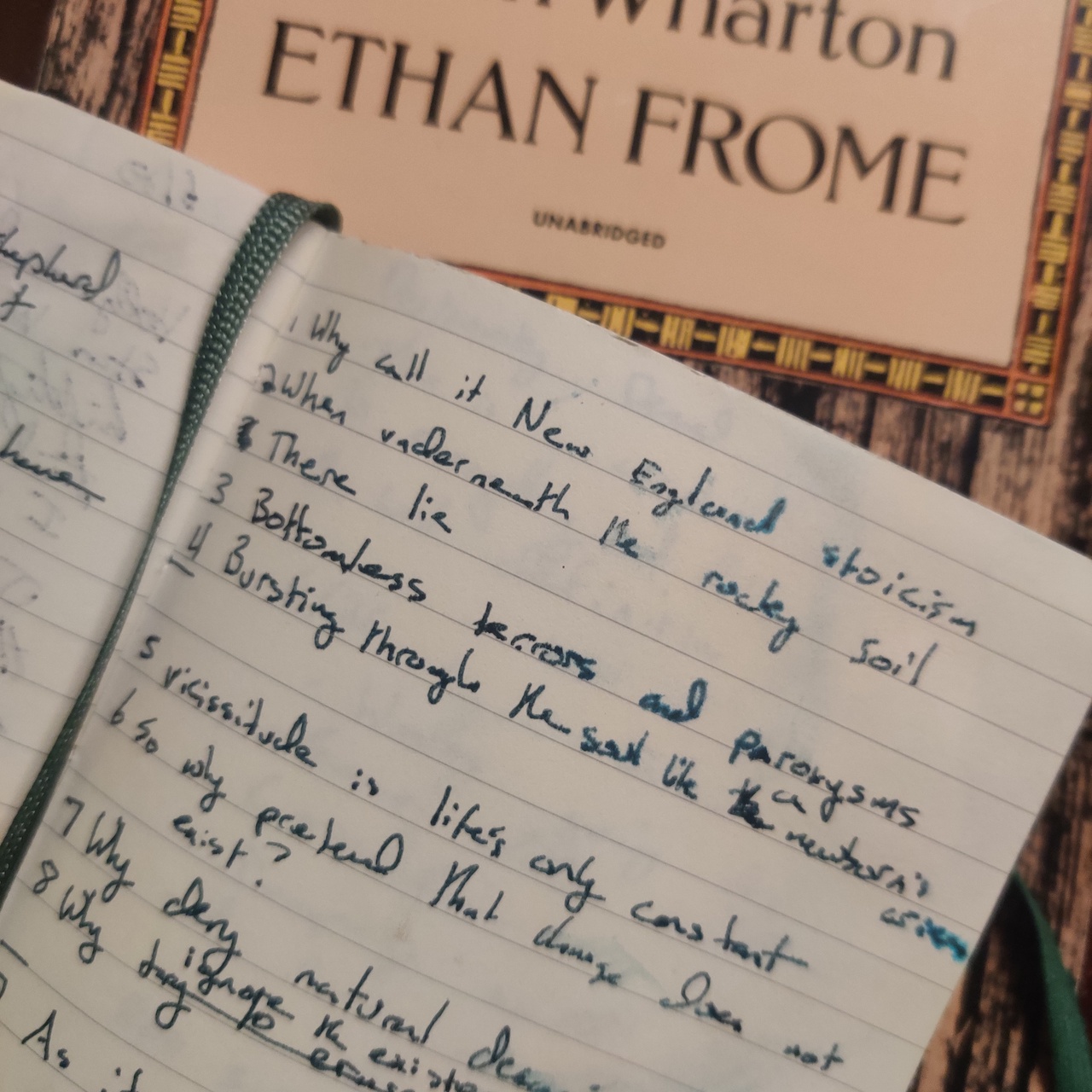 My notebook in which I drafted this sonnet on top of Ethan Frome