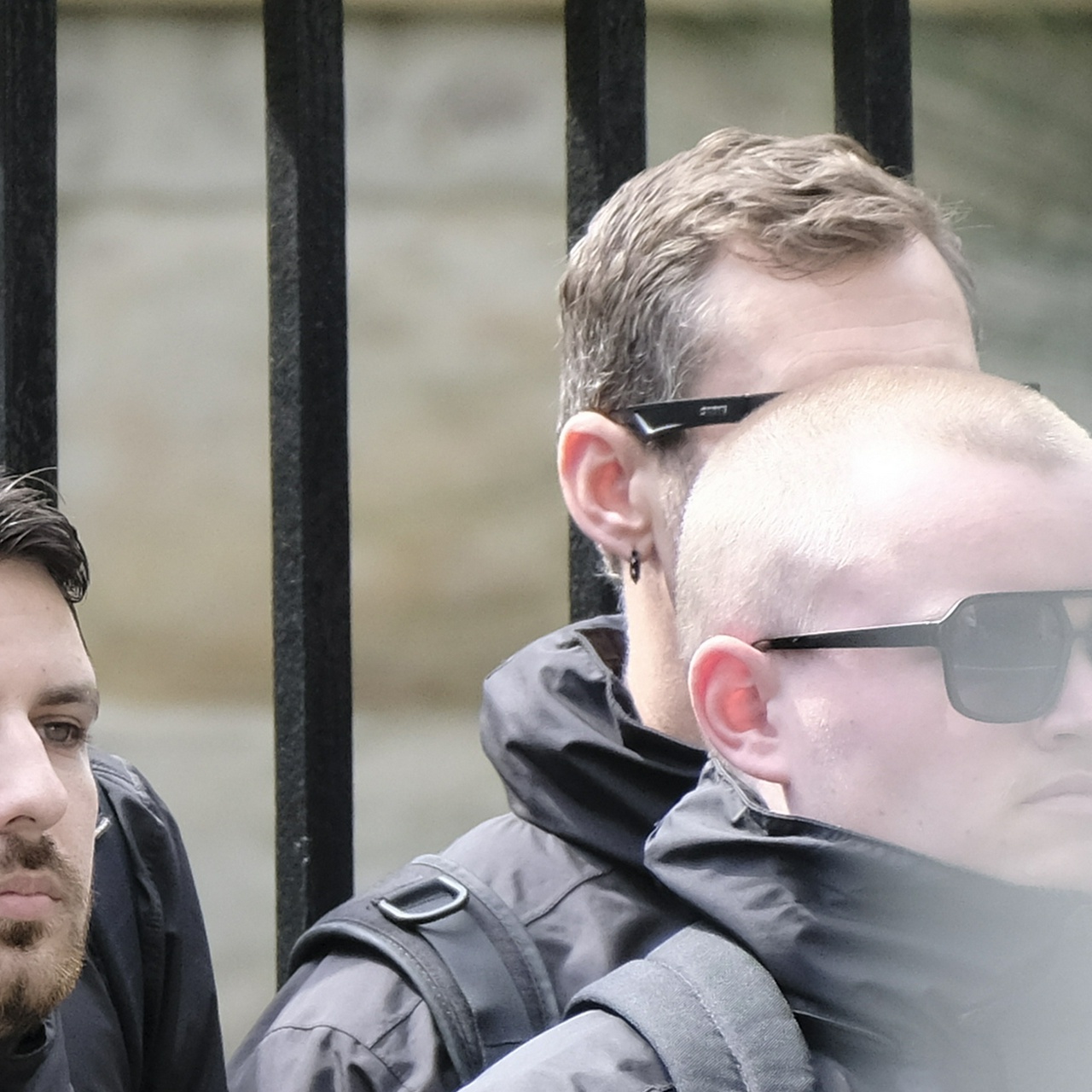 An angle showing one of that guy's pierced ears with a spiked black ring in each, and his greying head hair