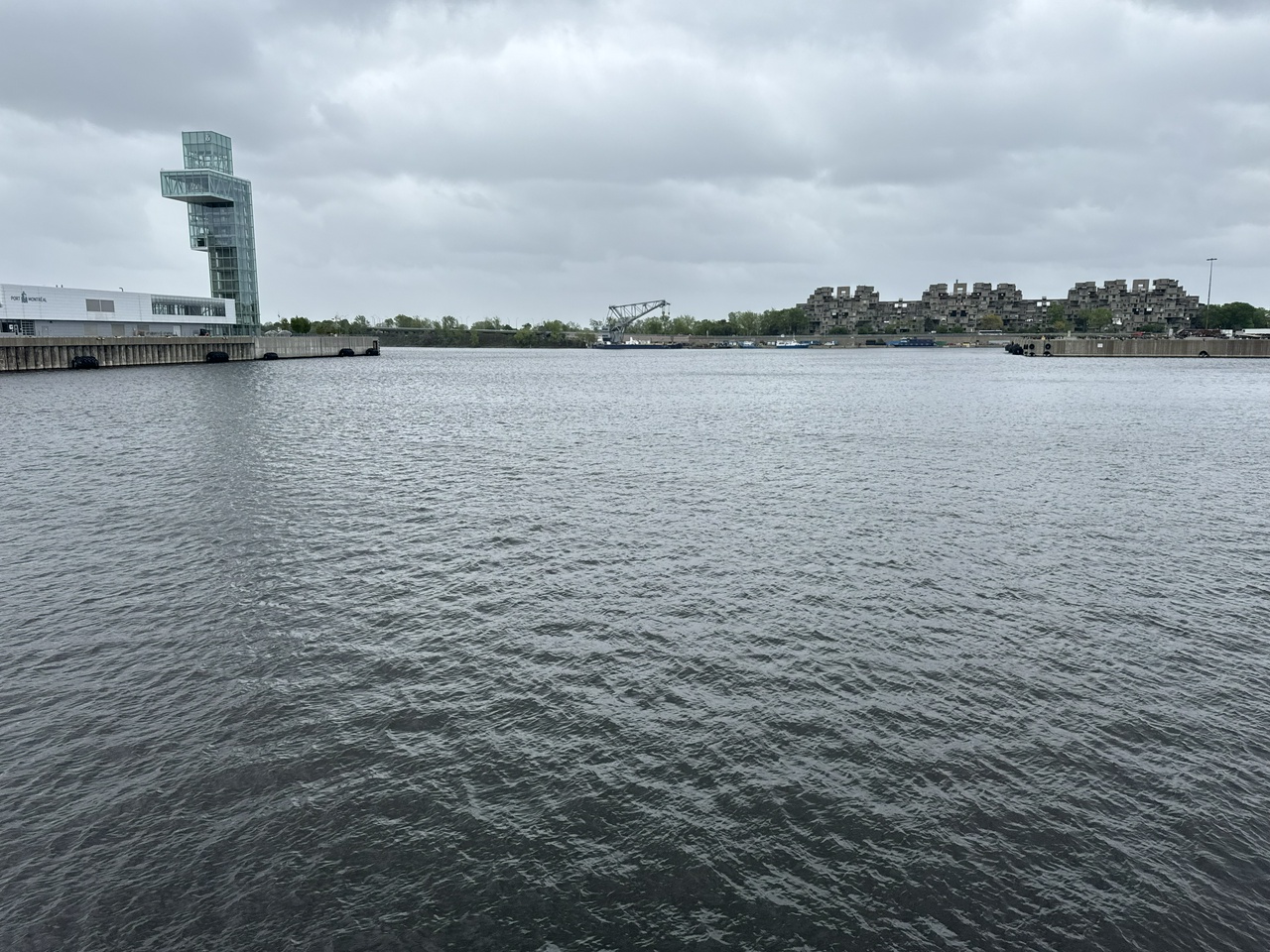 The basin at the Port de Montréal on an overcast day, grey water rippling in the foreground.