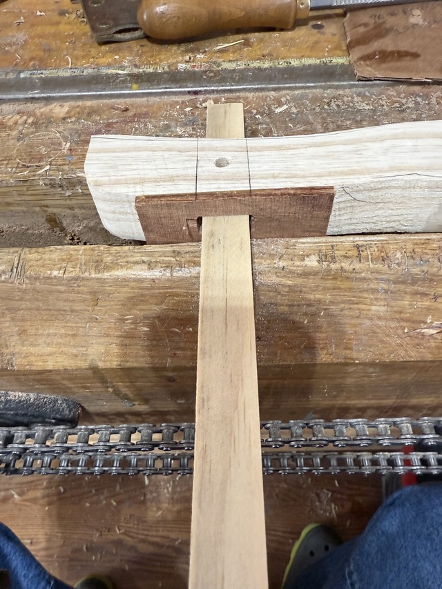 Using a rectangular stick to check the inside of the mortise