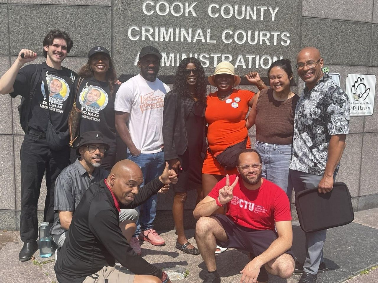 A group of people posing in front of a courthouse.
