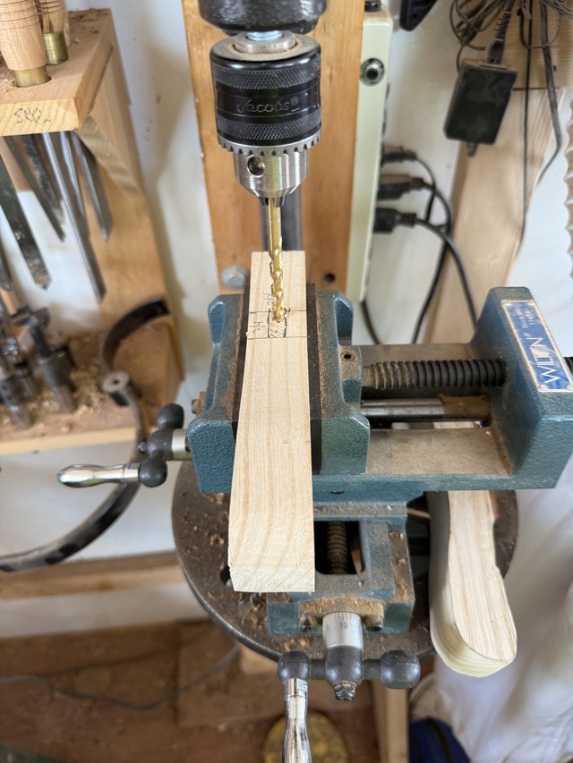 A cane handle is held in a cross-slide vise on a post-drill (a hand-powered drill press)