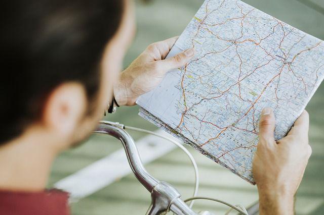 A cyclist checking a map