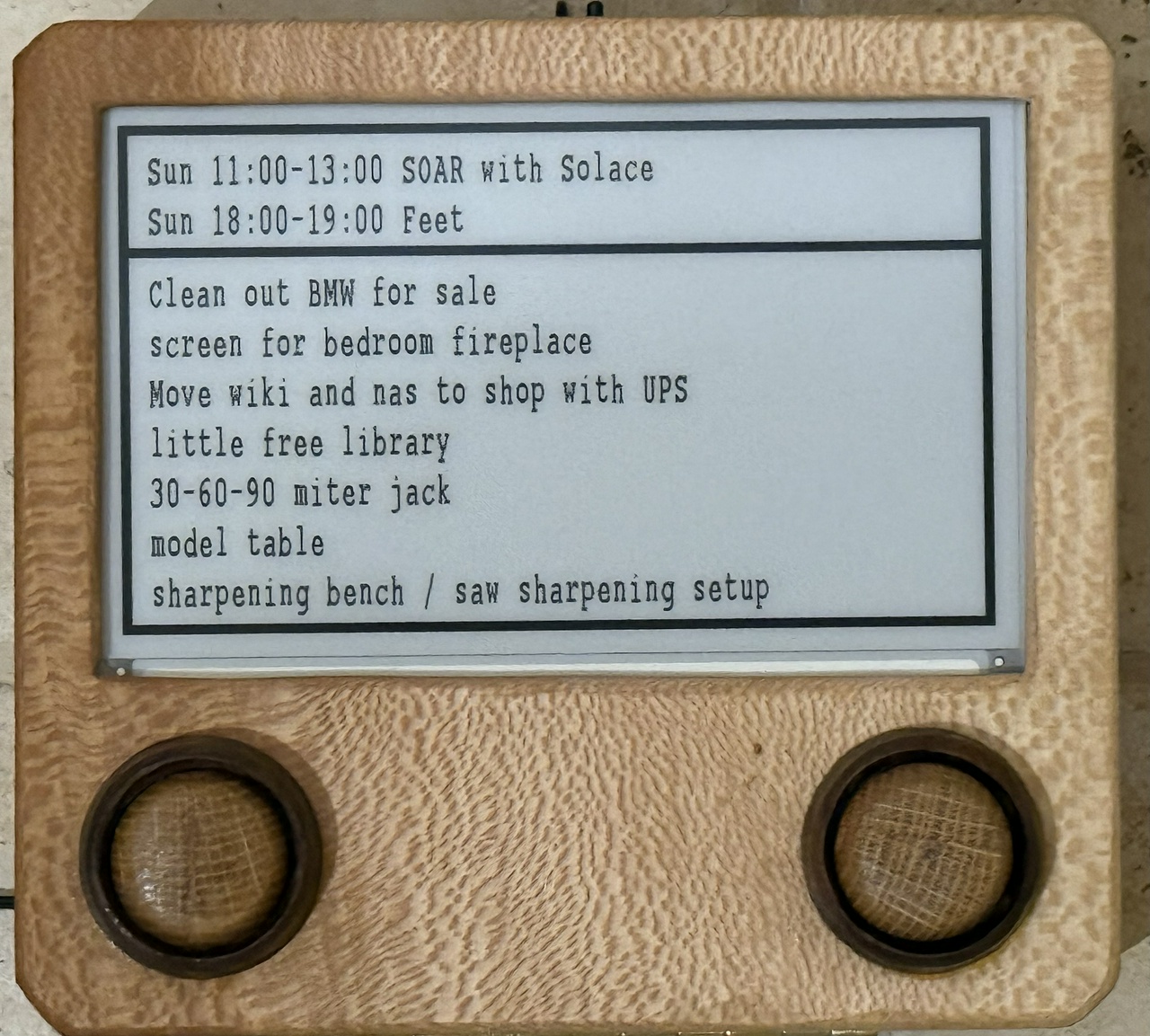 A wooden tv-shaped display showing events for "Sunday" and the top items on my to-do list
