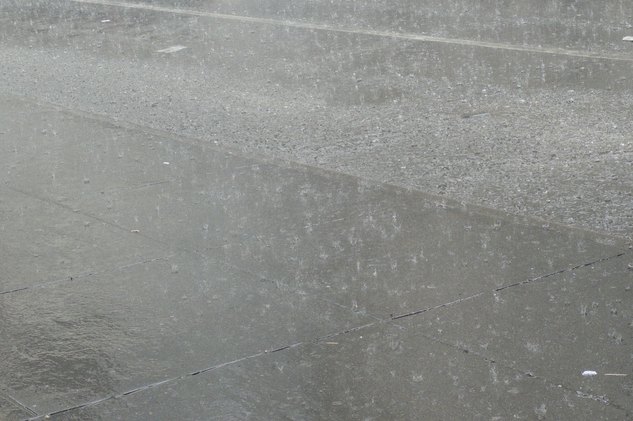 Rain on 32nd Street off 5th, curb, afternoon, June 22, 2026