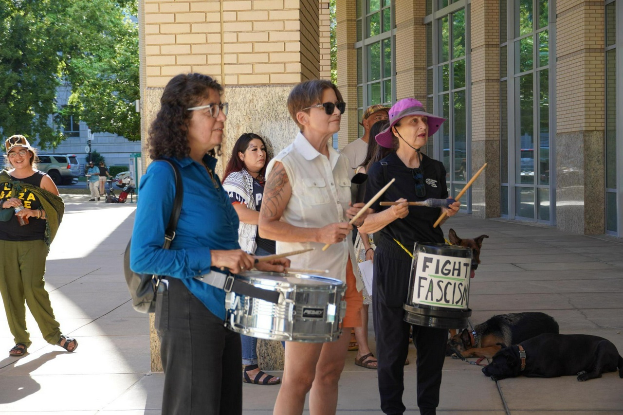 Protest at city council hearing demands protections for immigrants.