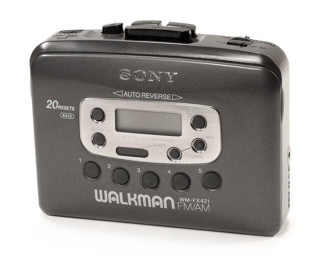 A compact, grey Sony Walkman with FM/AM radio. The player is labeled Sony, advertises Auto-Reverse, and says it has 20 presets. The player has several buttons and controls on the top edge. These aren't fully visible. The front face has a small LCD display along with soft buttons for controlling the radio functions.