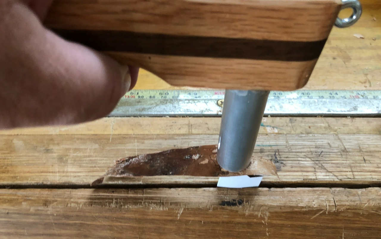 Using the shop-made tool to push down a layer of birch-bark