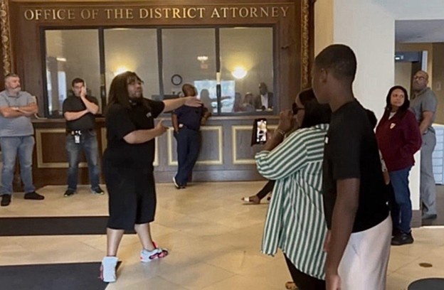 PAARPR members and Aaron Rainey’s family in the district attorney’s office, demanding answers regarding Rainey’s case.