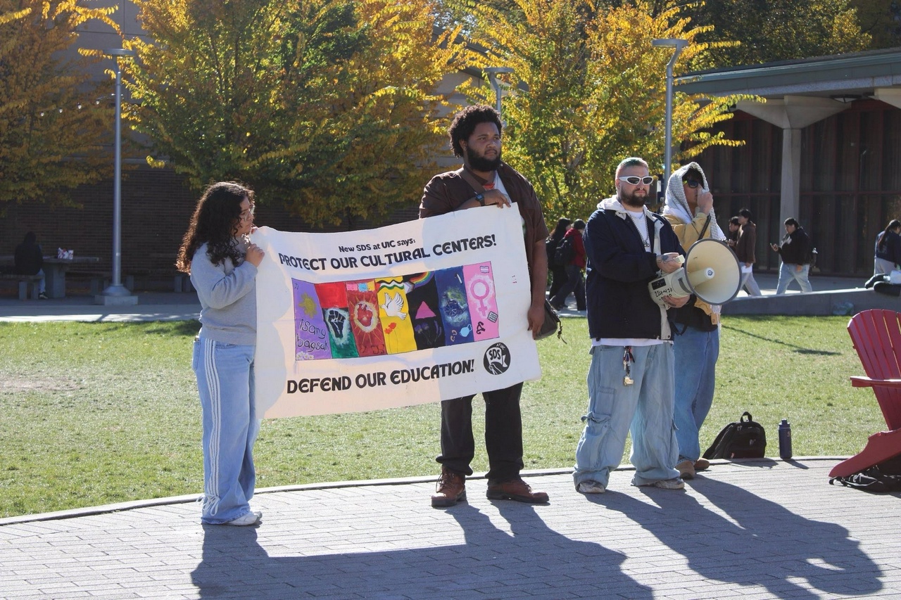 People standing holding a banner