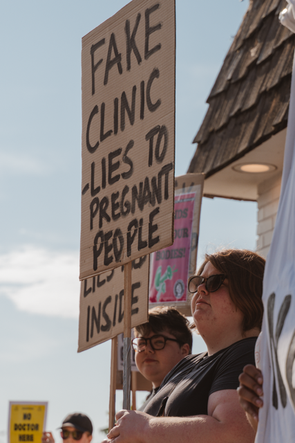 Protesters holding signs.