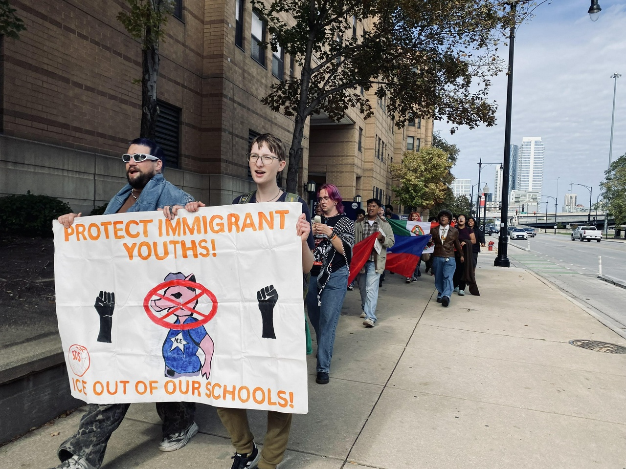 Students are cheered on by workers and bystanders as they march down on campus.