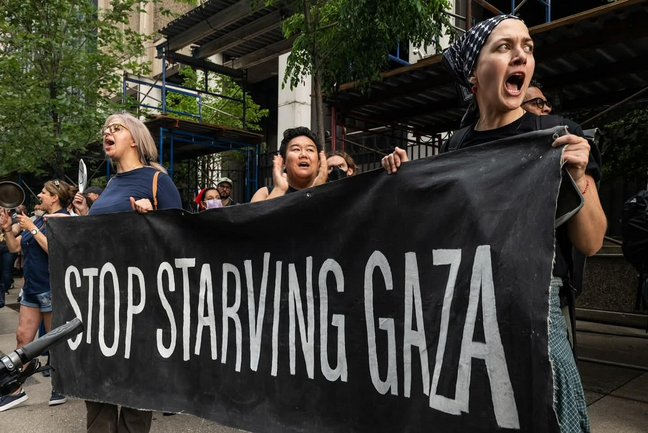 A group of protesters holding a banner.
