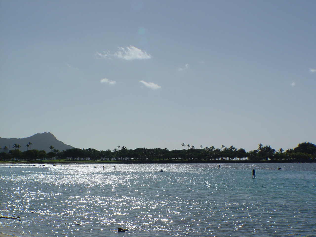 Taken by the humble author; depicts the ocean with paddlers and swimmers, the mountain known as Diamond Head is in the distance on the left hand side.