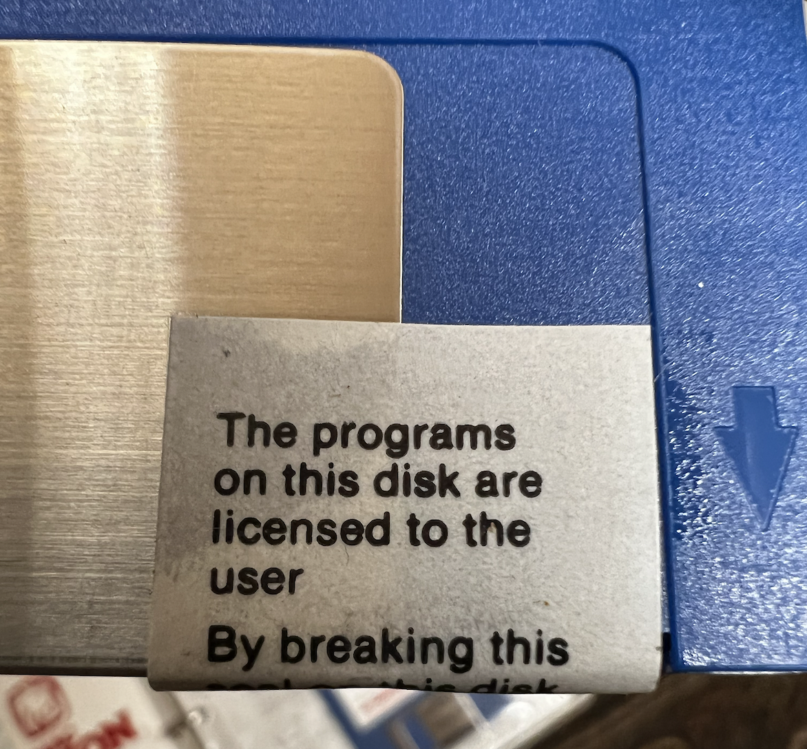 Sealed floppy disk with sticker over disk door