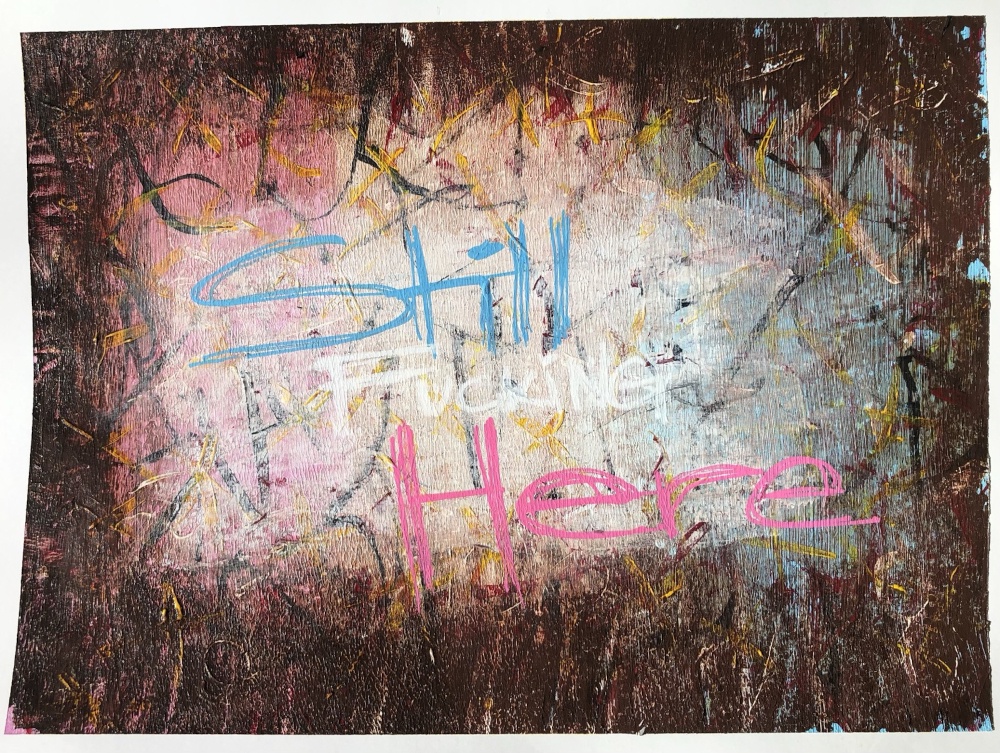 Still Fucking Here. a painting, acrylic on paper. in the faded, overpainted background are stripes of pink, white, and blue. There's a chaotic confetti of color stacked upon it, overpainted with burnt umber, wiped away. On top of all that, the words in pink, white, and blue: Still Fucking Here.