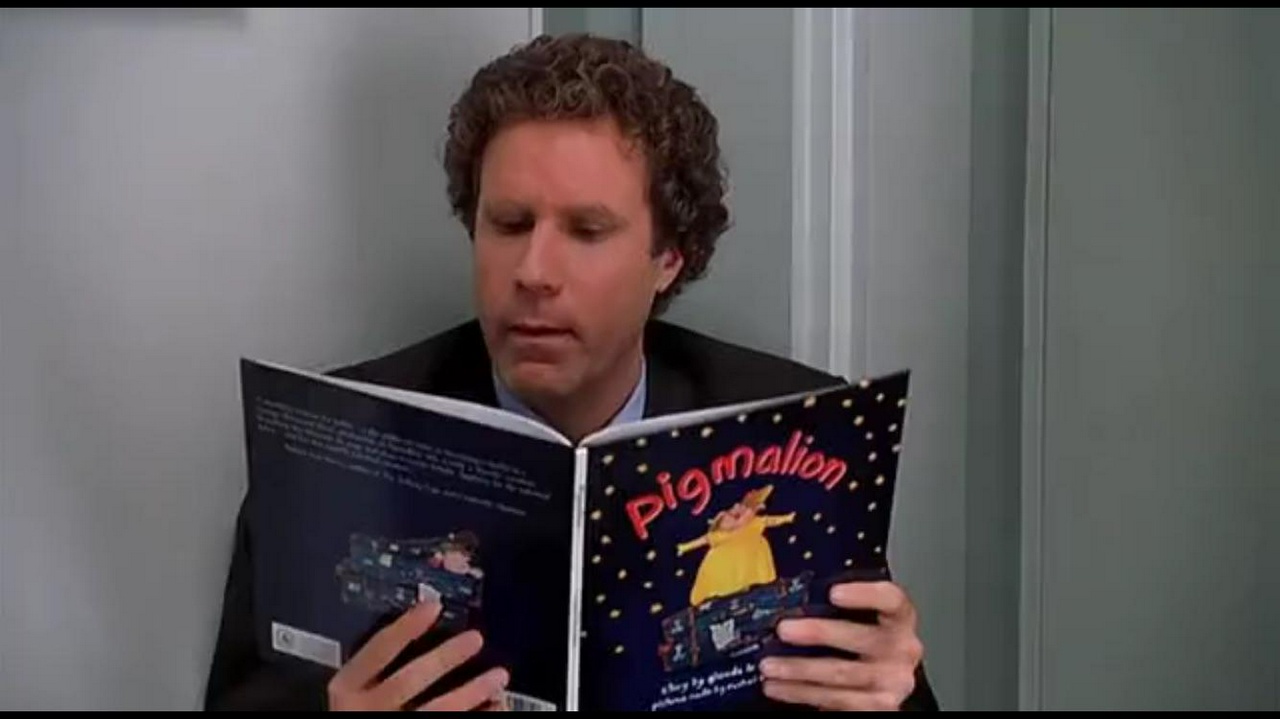 Buddy the Elf reading a children's picture book titled Pigmalion