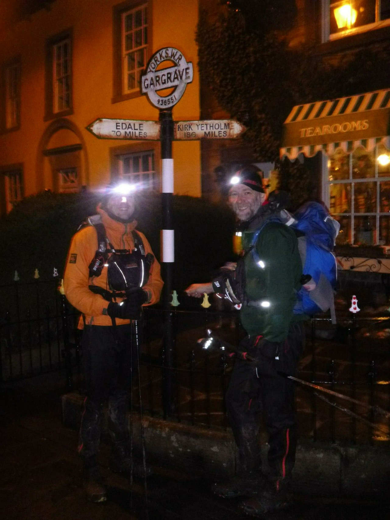 two runners by a sign