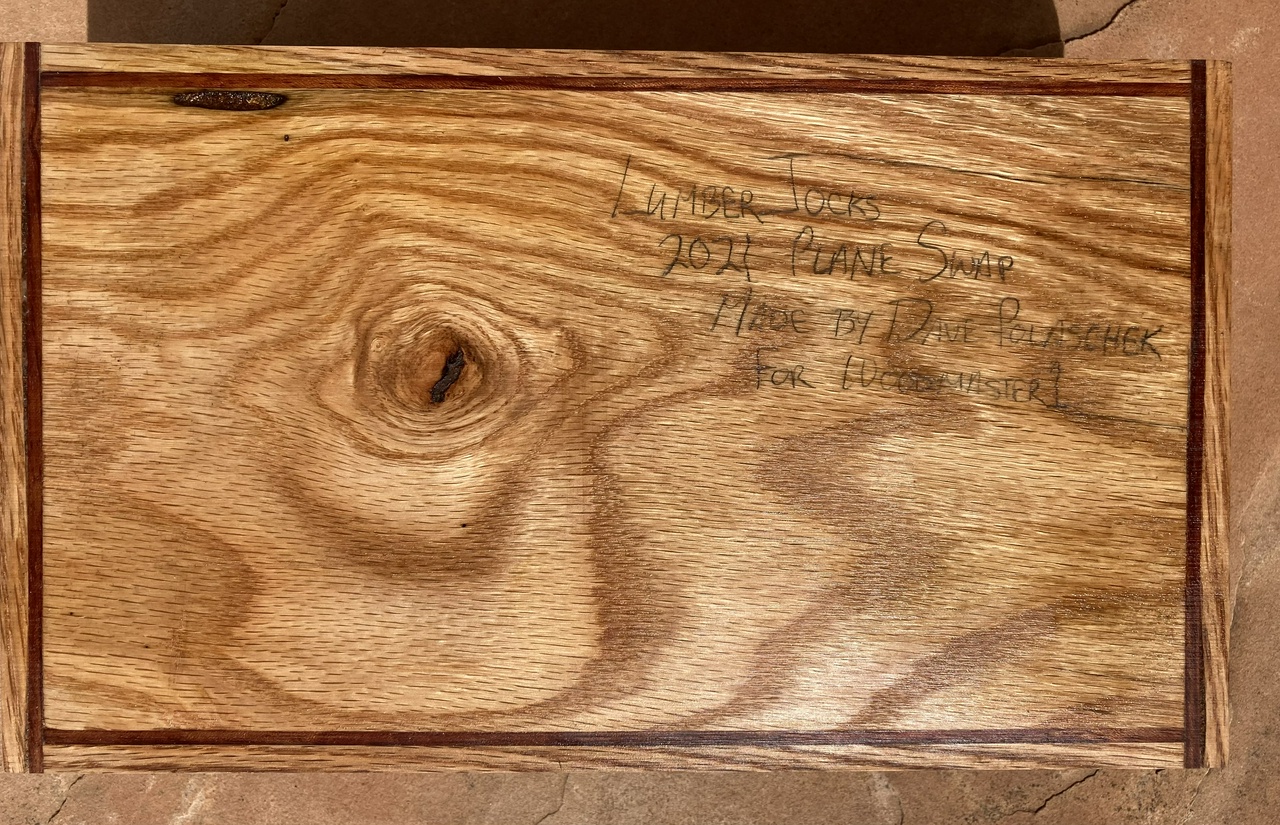 Box, closed, showing the top with the note saying "Lumberjocks 2021 Plane Swap, Made by Dave Polaschek for Woodmaster1" in pencil