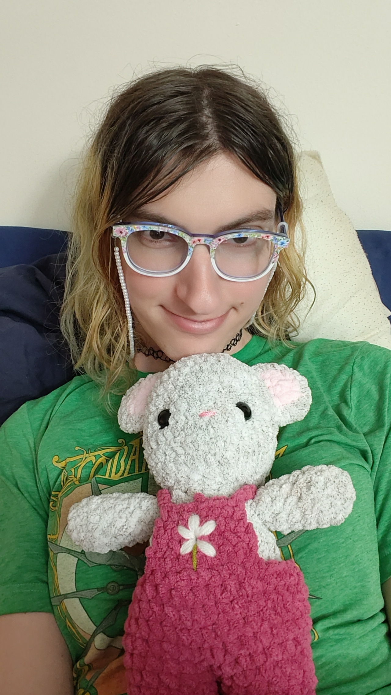 A girl holding a white mouse stuffie.