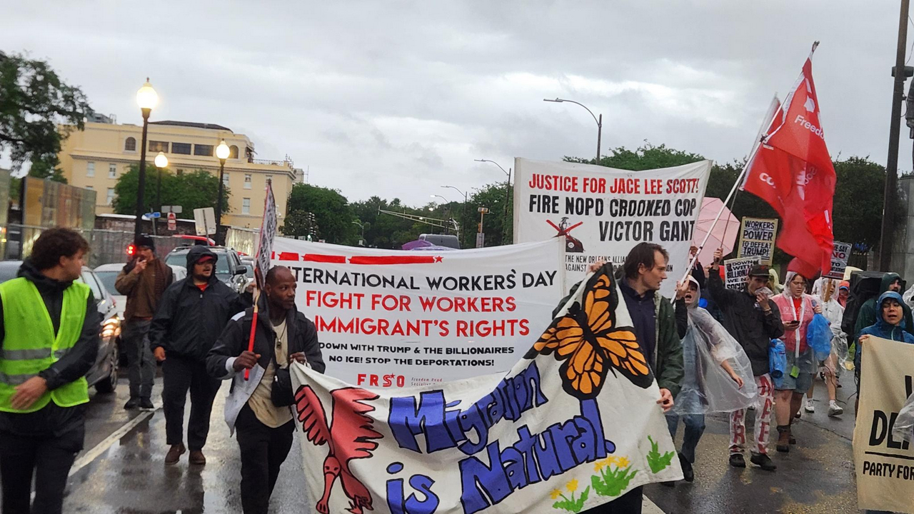 Protesters march down Basin Street for International Workers' Day.