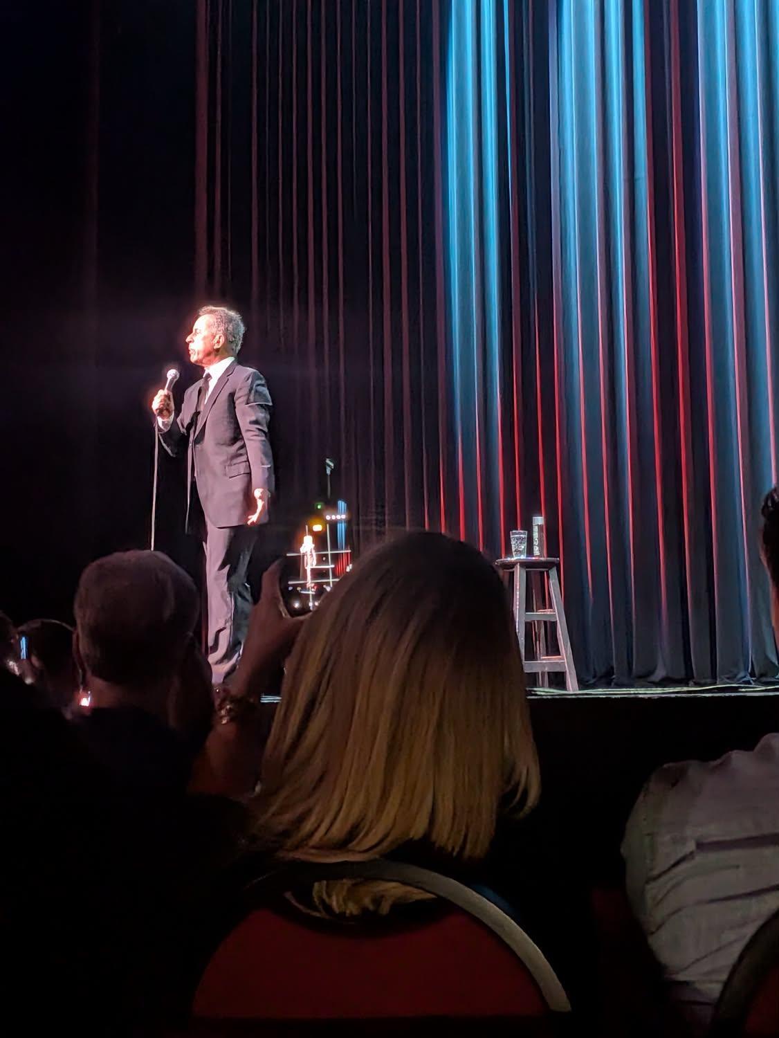A man in a suit on a stage.