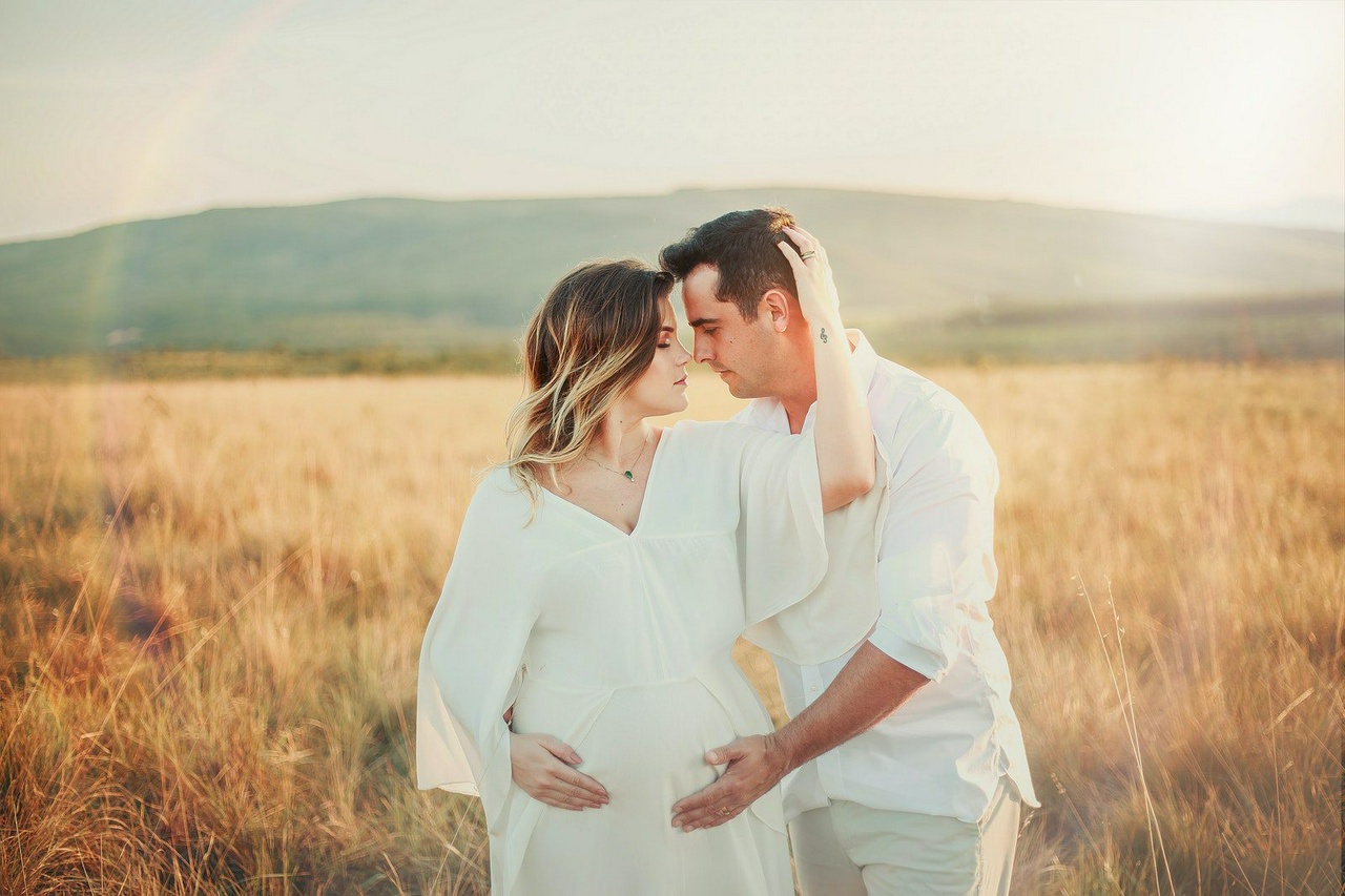 Pregnant Couple In A Field