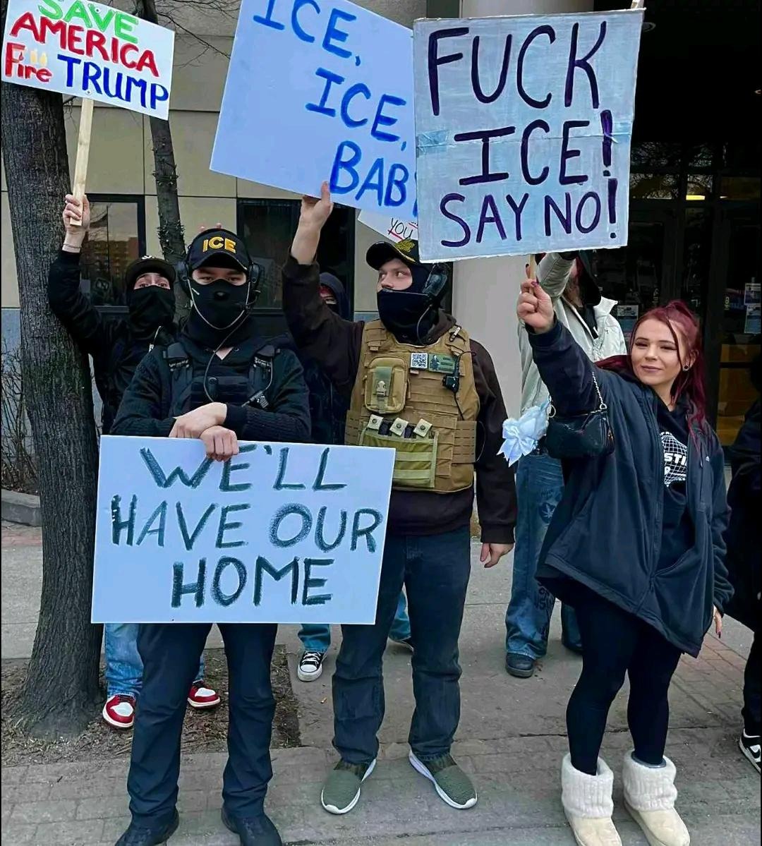 Immigrant rights activists move to surround armed pro-ICE counter-protesters.