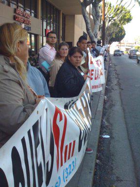 Women carrying banner that says, "Escuelas si... Centro CSO"