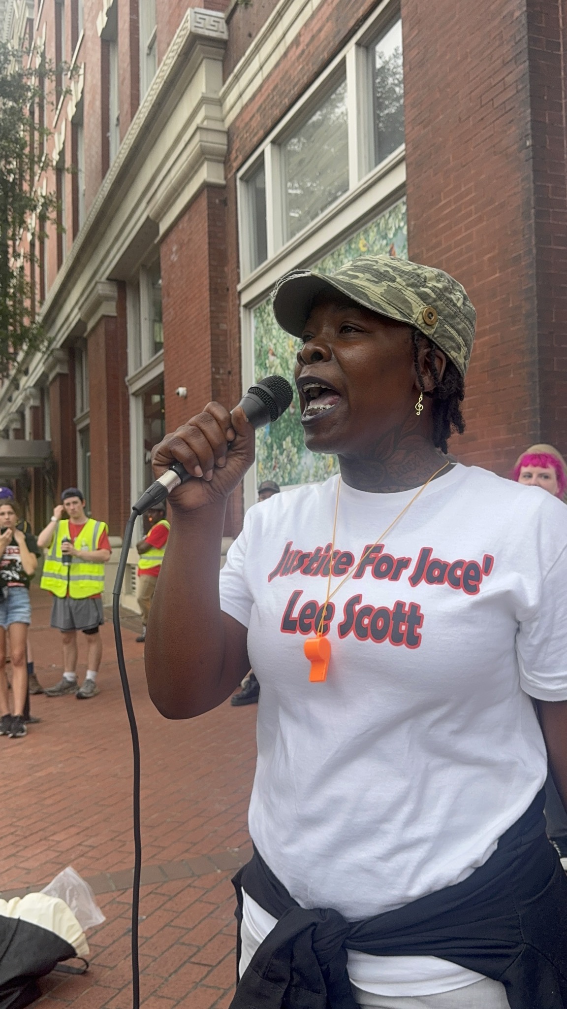 Shanta Scott chants across the street from Ogden Museum's  Magnolia Ball Fundraiser, shouting ‘Helena Moreno do what's right, stand with the families, help us fight!’  | Fight Back! News