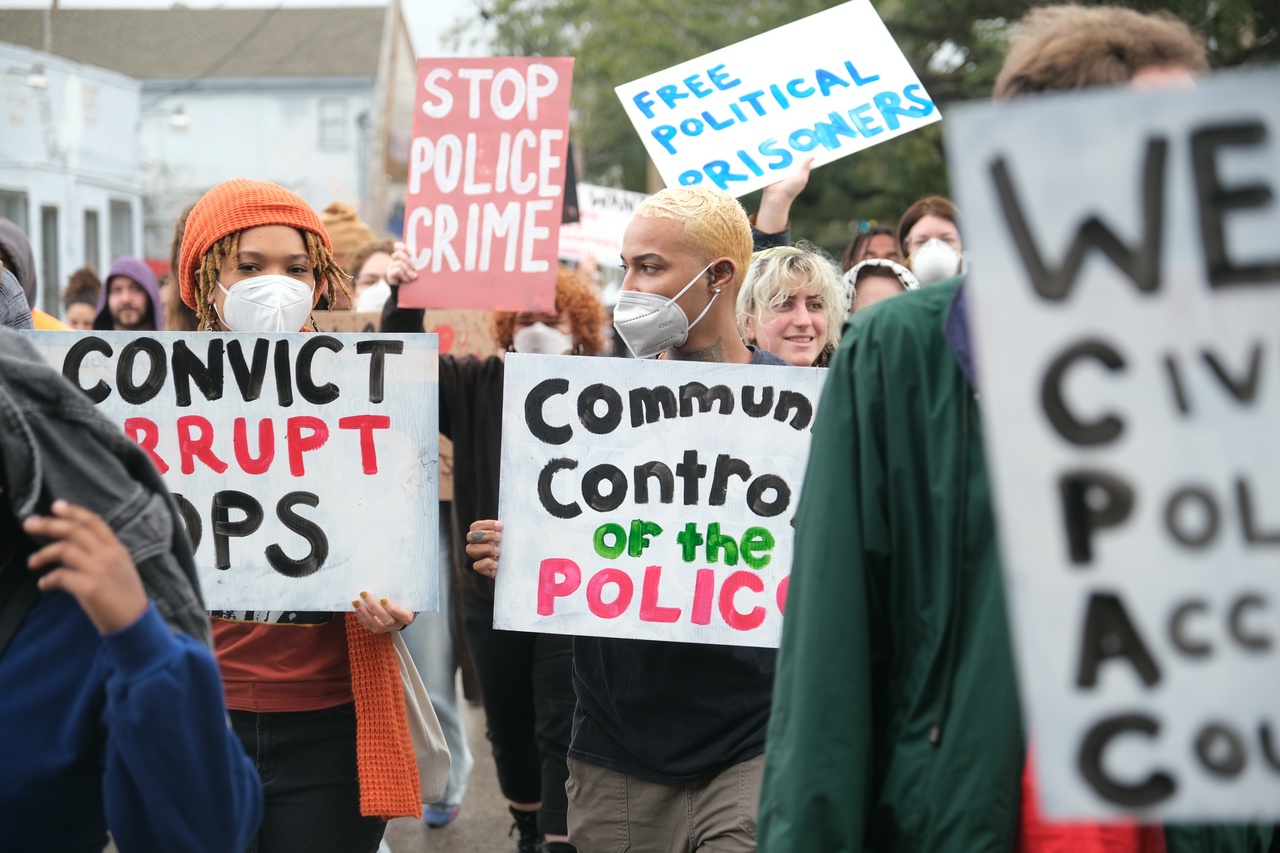 A group of protesters holding signs.
