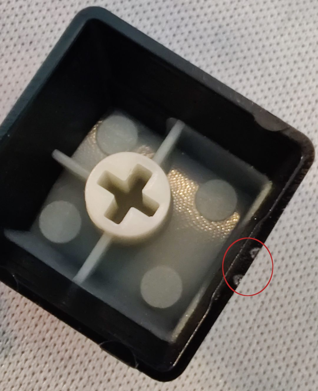 Image: Bottom of key cap showing jagged bumps.
