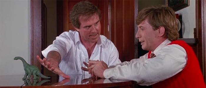 Charles Grodin tries and fails to hold Clifford's attention by blocking a toy dinosaur from Clifford's line-of-sight with his hand