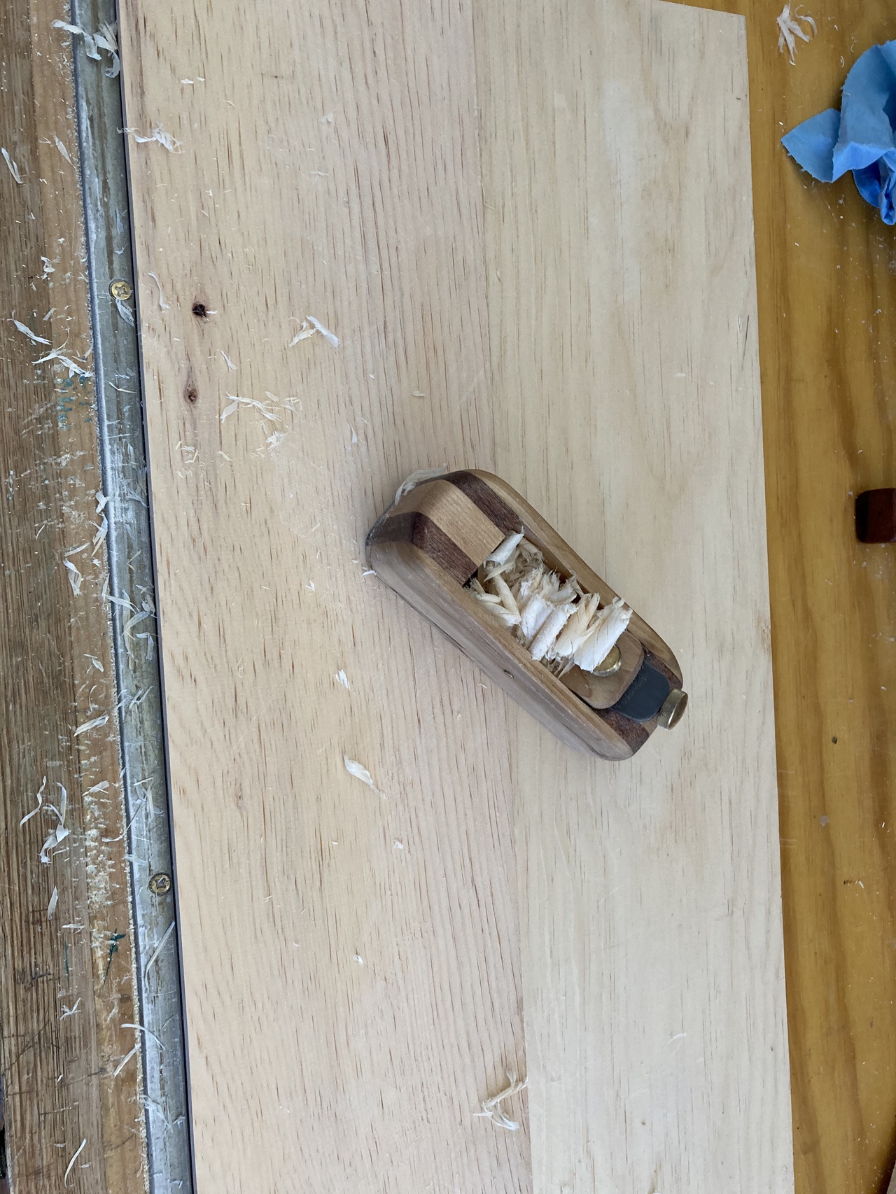 Hand-plane oriented diagonally across the seam of the glued-up 1x8s