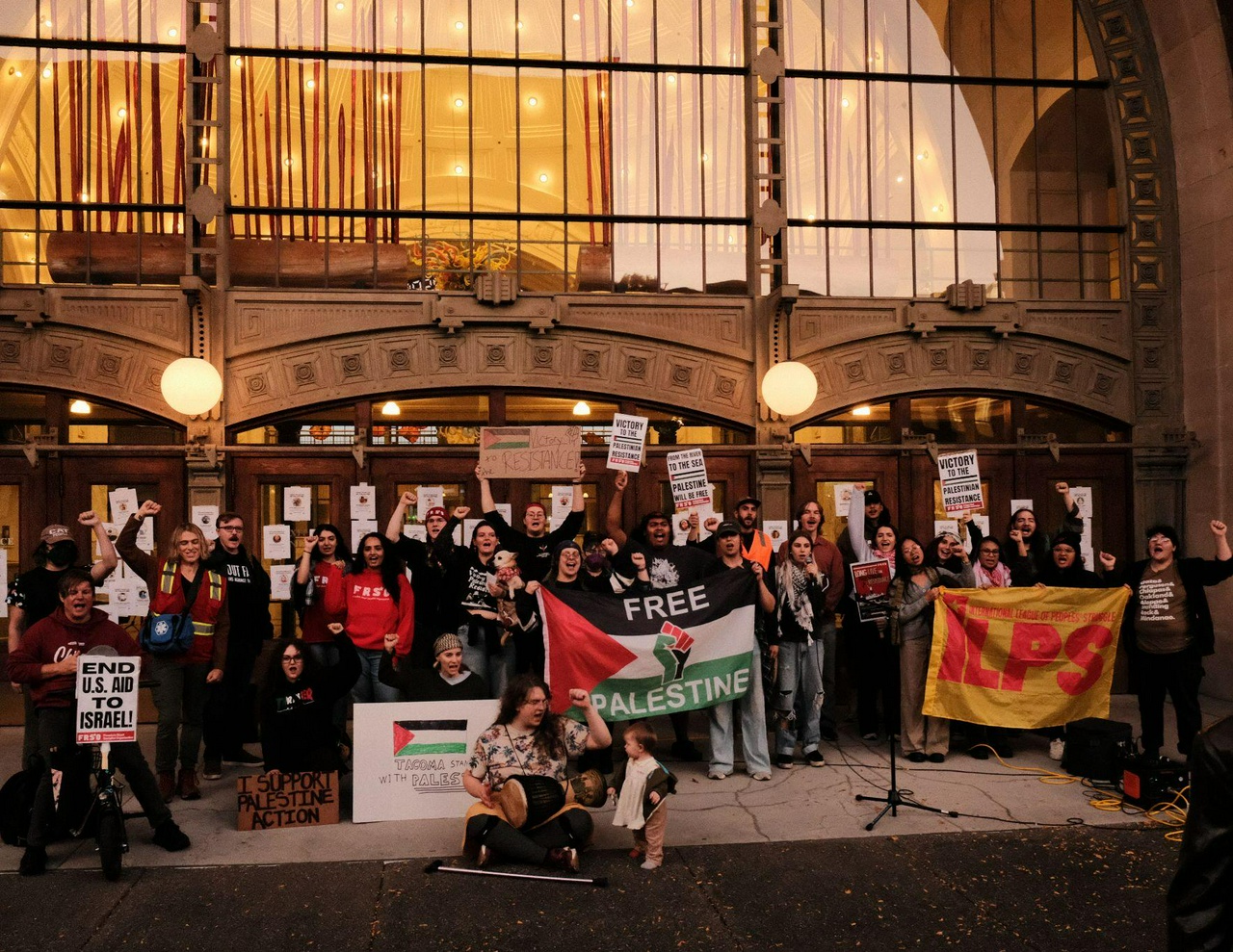 October 7 rally in solidarity with Palestine in Tacoma, Washington. | Fight Back! News A group of protesters with signs outside a building.