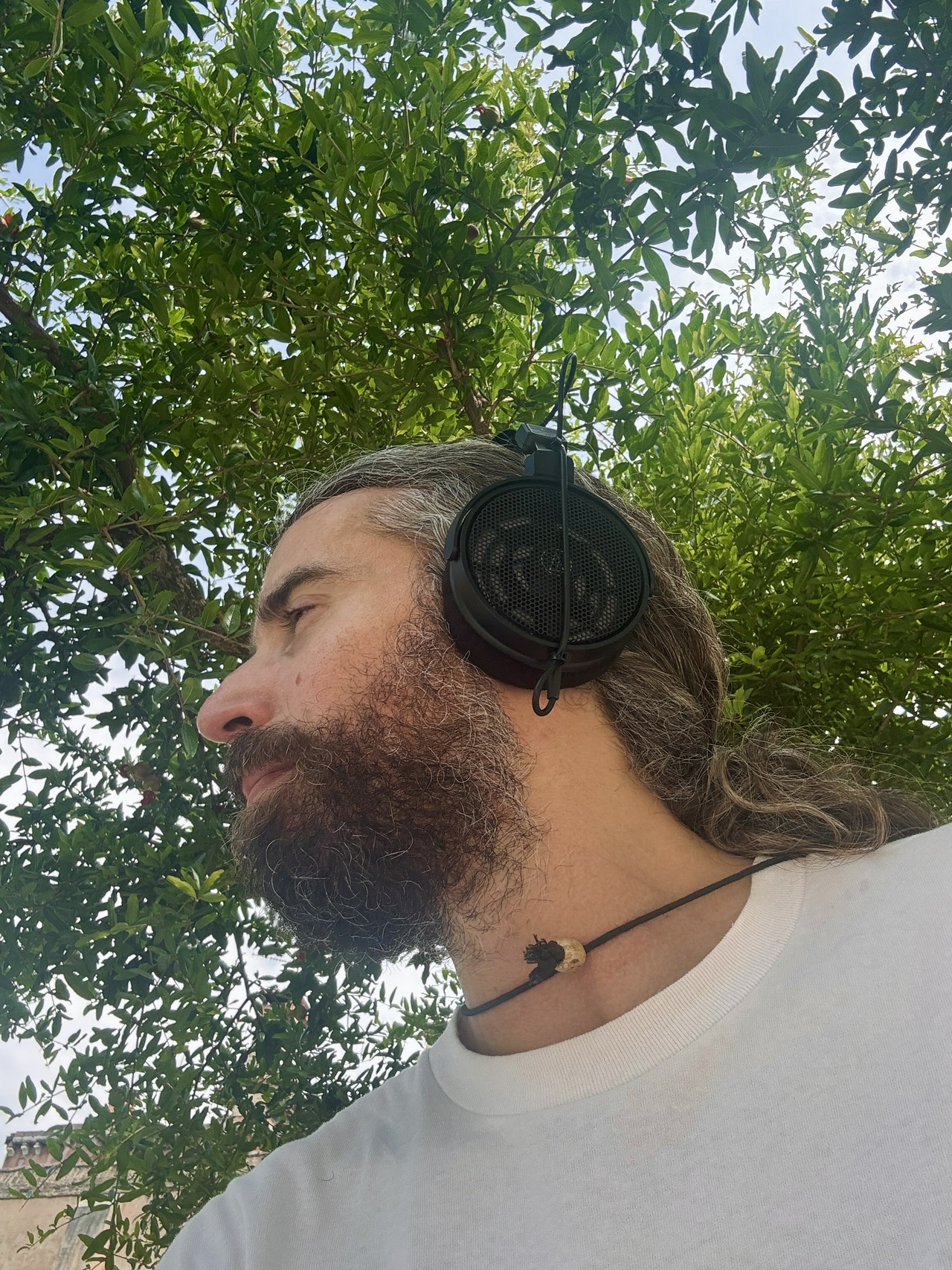 Photo of the writer wearing headphones in the garden