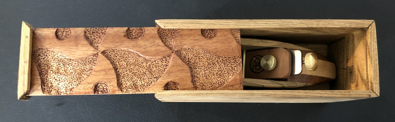 Open box, showing the plane inside it