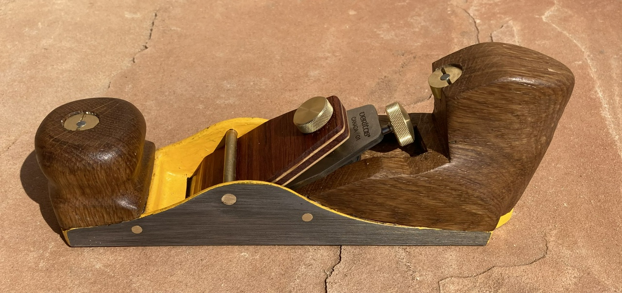 A low-angle infill plane with yellow-painted metal bits and white oak furniture, viewed from the left side