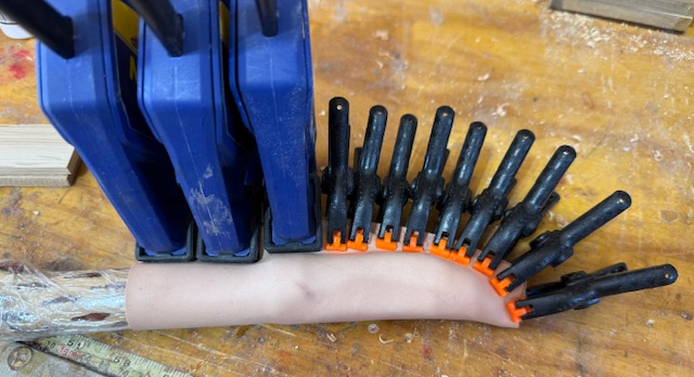 Wet leather, wrapped around the knife and insert, which have been protected by plastic wrap, and then clamped tightly against the knife