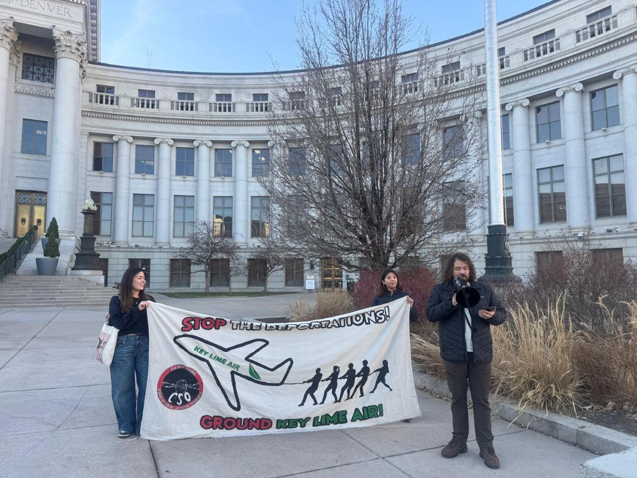 Denver protest demands end to deportation flights.