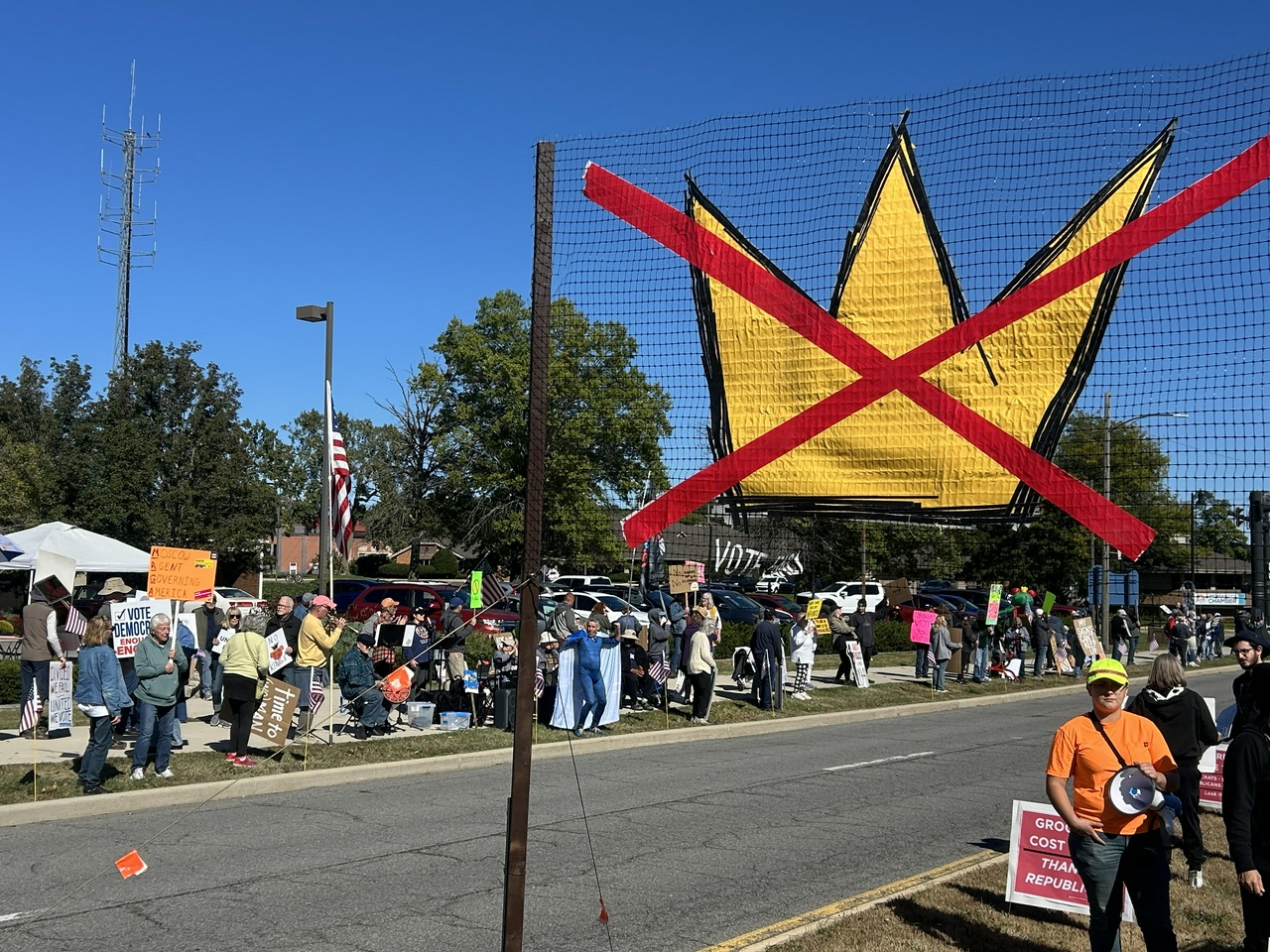 Protesters standing on the side of a road.