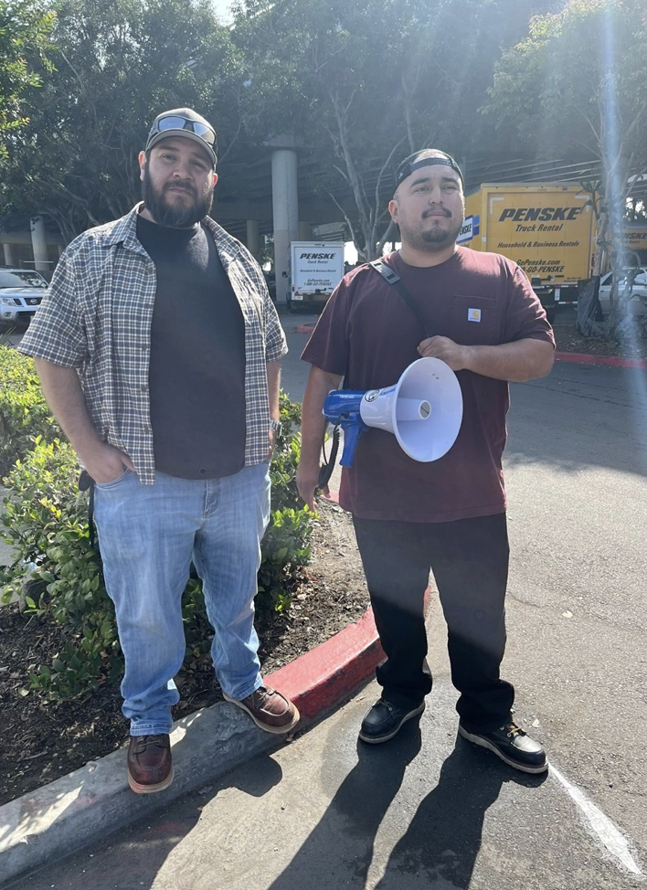 Sam Carrera on the right with bullhorn at Cypress Park Home Depot, November 4.