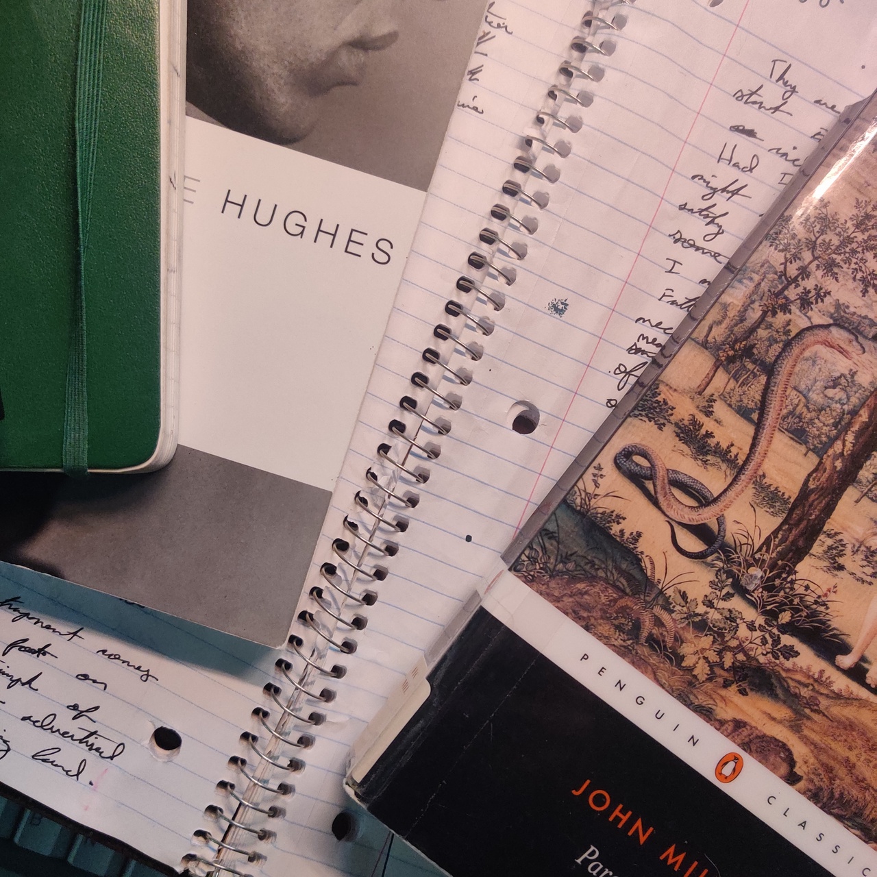 a picture of my notebook with Paradise Lost and Hughes on top of it