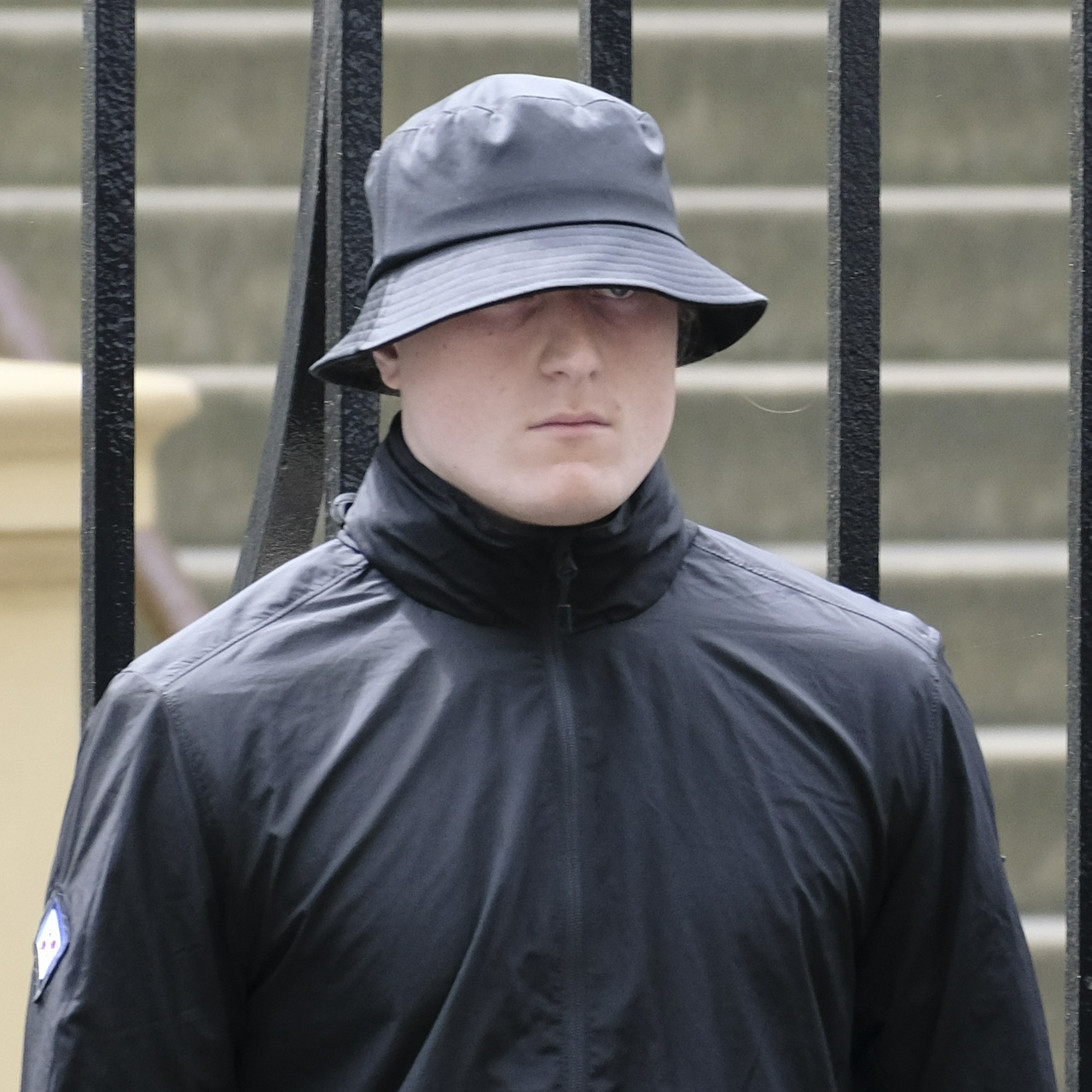 Oscar Tuckfield's wide face trying to hide behind a small bucket hat