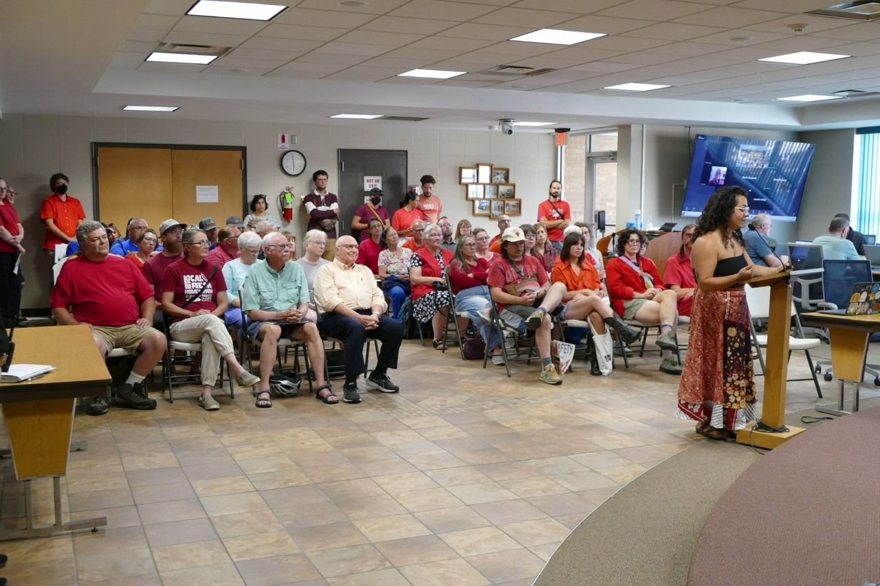 The city council room is packed with supporters all wearing red in demonstration of their support for a sanctuary city separation ordinance in Decorah, Iowa.