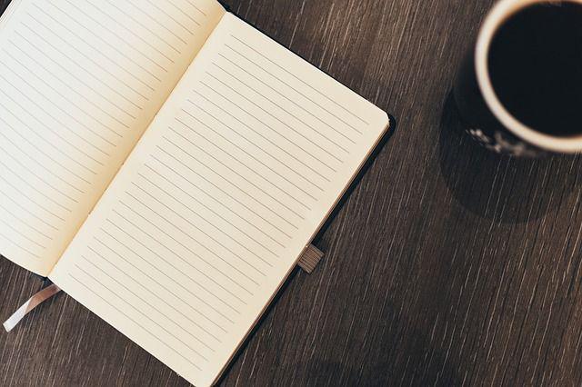 A notebook and a cup of coffee